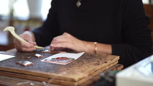 A woman making a stained glass work