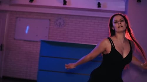 Attractive Talented Woman Dancing Modern Choreography on Blue Neon Background in Studio