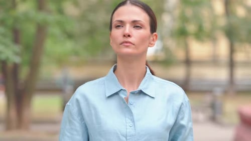 Young Woman Looking at Her Watch Outdoors