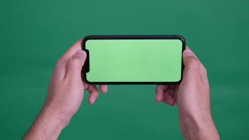 man holding green screen phone