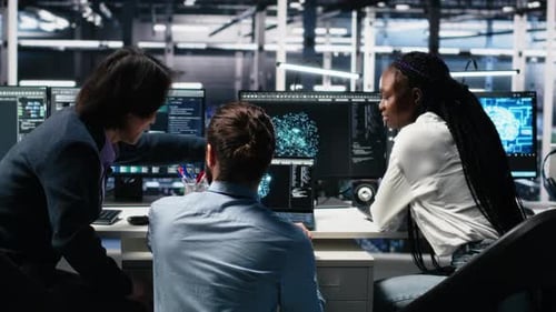 Team of Programmers Collaborating at Computer Workstation