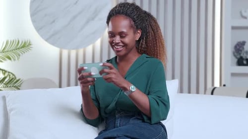 Woman Playing Mobile Game on Smartphone, Cheering Indoors