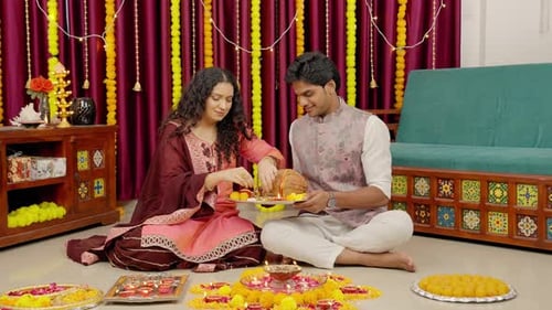 Couple Performs Religious Ritual in Decorated Home