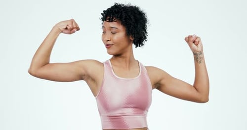 Woman Flexing Biceps in Gym Attire