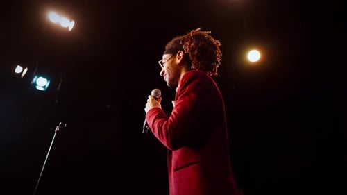 Standup Comedy Performance Joyful Black Man Talking to Microphone and Smiling Portrait of Host of