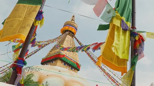 Tilting clip of strings of multicoloured prayer flags at sacred Buddhist temple in Nepal