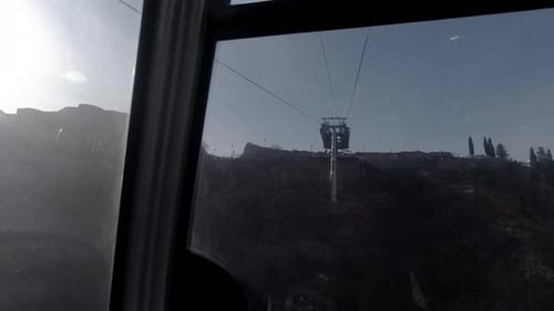 Riding an aerial tramway up to the destination