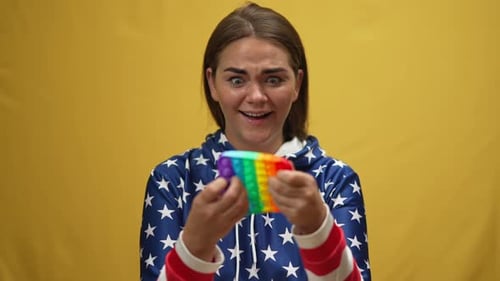Young Woman Happily Plays with Pop It Toy
