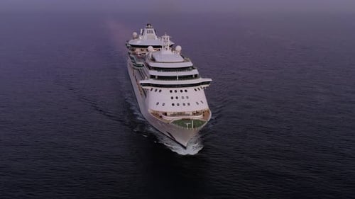 Mega Cruise Ship sailing slowly across the sea, Aerial footage.
