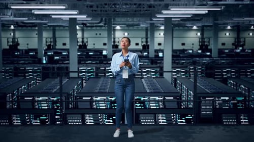 Full Body Of Asian Business Woman Using Mobile Phone An Looking Around In Data Center