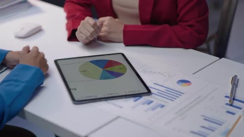 Business People Discussing Data Statistics on Tablet