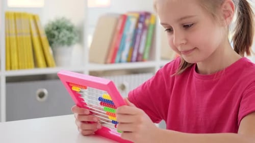 Girl Learning Math with Colorful Abacus Indoors