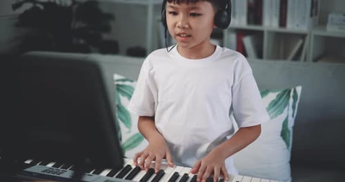 Child Plays Electric Keyboard at Home