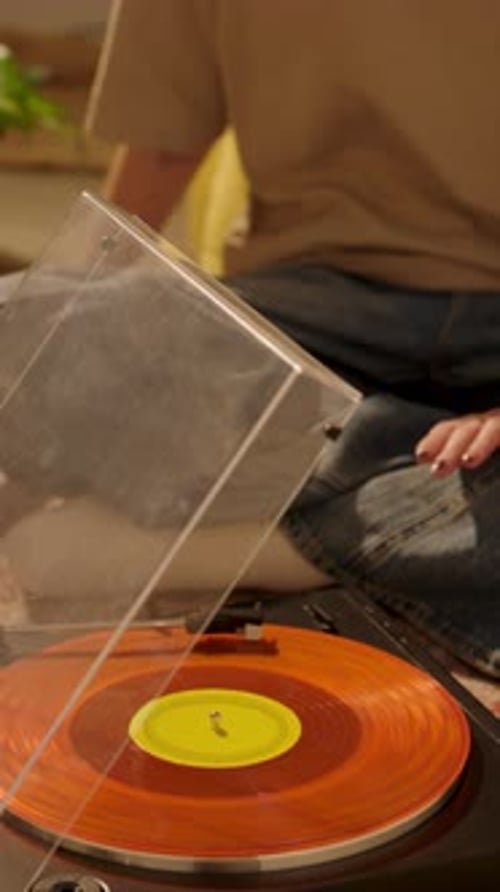Young Woman Listening to Record Indoors at Home
