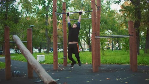 Man Doing Pull Ups at Outdoor Fitness Park