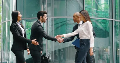 Young Business Professionals Meeting and Shaking Hands