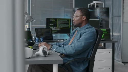 African American Male Software Developer Coding in Office
