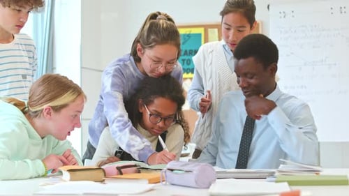 Teacher Assists Students with Classroom Assignment