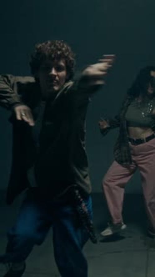 Two Freestyle Dancers with Flashing Lighting illuminating Scene Vertical
