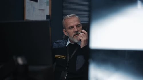 Security Guard Talking on Radio and Drinking Coffee