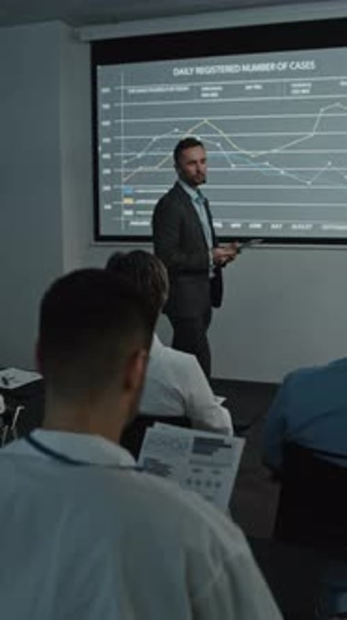 Man Giving Presentation to Seated Colleagues