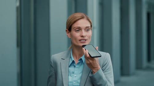 Professional Woman Using Voice Assistant on Smartphone