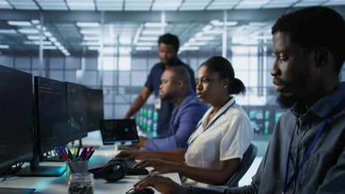Workers Collaborating On Software in Modern Office