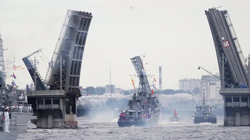 A Lot of Warships Goes Along the Neva River Under Open Bridges at the Time of the Celebration of the