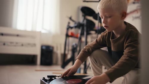 Young Boy Listening to Vintage Vinyl Records