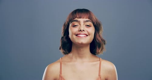 Smiling Woman Makes Heart Shape with Hands