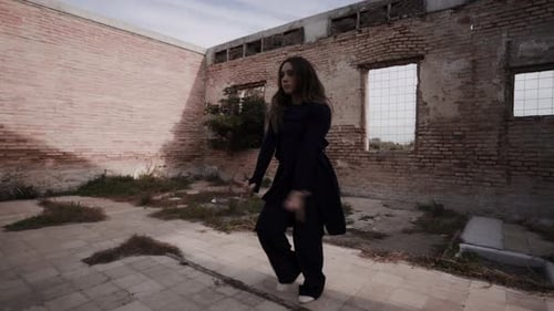 young blond woman dance in abandoned old building with open ceiling performing for night club party