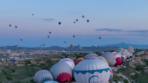 Hot Air Balloons Fly Over the Mountainous Landscape of Cappadocia Turkey