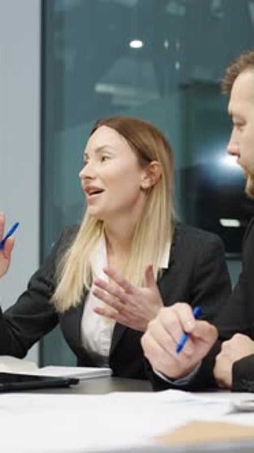 Businesswoman Leading Office Meeting with Colleagues
