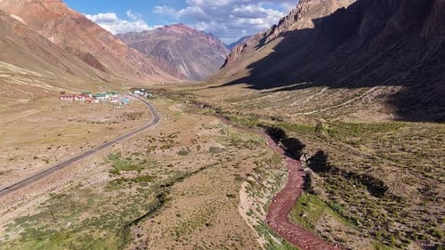 Aerial Photo of Andean Valley with Road Winding Through Mountains Showcasing Remote Wilderness