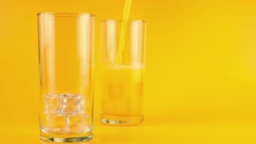 Refreshing Orange Juice Poured into Glass with Ice