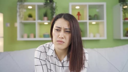 Sad Woman Cries in Bright Indoor Setting