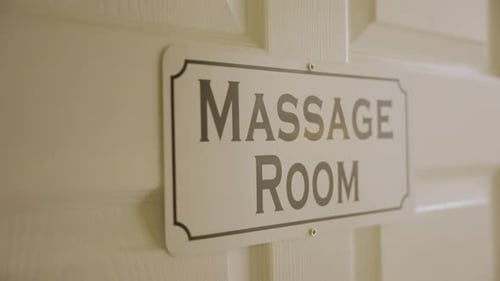 The door of the room at the massage center is labeled "Massage Room."
