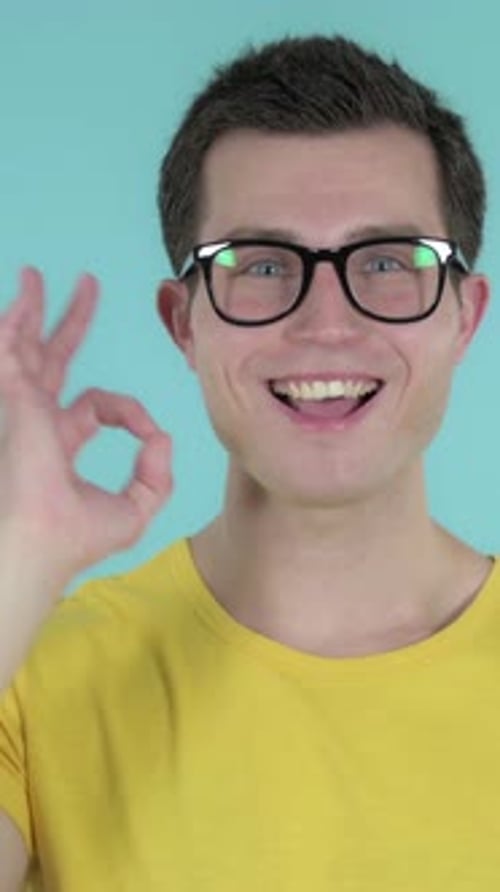 Okay Sign by Man, Blue Background, Vertical Video