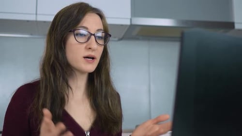 Smiling Businesswoman Making Conference Video Call on Laptop Working in Home Office