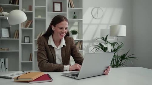 Young Woman Video Conferencing From Bright Home Office