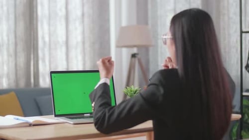 Asian Businesswoman With Green Screen Computer Being Happy Successful While Working At Home