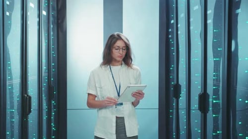 A Professional Woman Effectively Managing Data in a CuttingEdge Modern Server Room