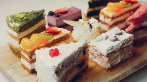 Delicious Variety of Cakes on a Cutting Board