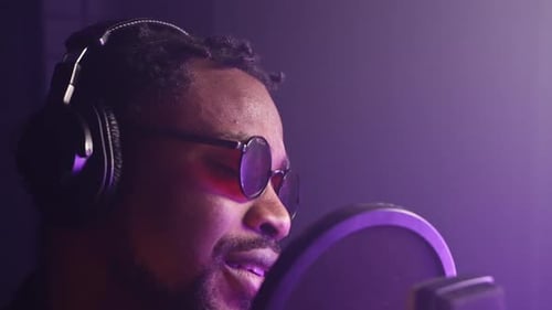 Handsome African American Man with Headphones is Recording New Song in Professional Studio Portrait