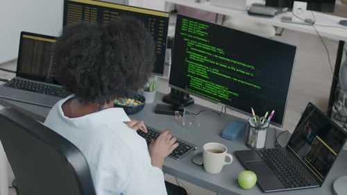 Black Female Software Engineer Typing Code on Computer