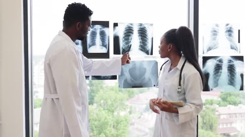 Healthcare Professionals Discussing Xray Images in Medical Clinic