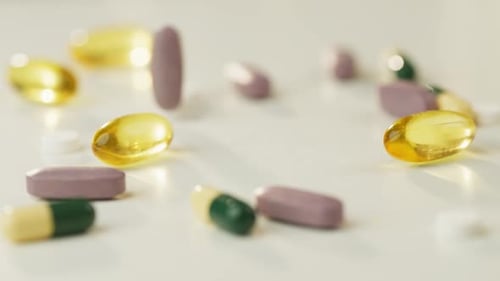 Colorful Supplements and Pills on White Surface