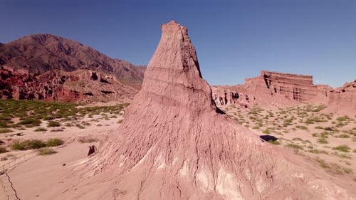 Stunning Rock Formation Towers Over a Vast Desert Landscape Under Clear Blue Skies
