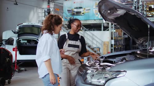 Repairman Showing Customer Car Changes