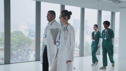 Team of Medical Specialists Walking along Clinic Hall